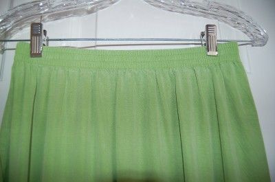 We are pleased to offer a gently used Tianello lime green short sleeve 